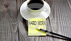 Business HARD WORK . Yellow stickers with text on wooden background with coffee