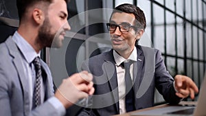 Business Having Meeting Around Table In Modern Office