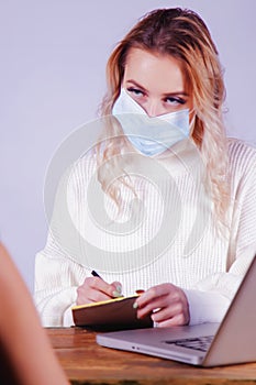 Business, health, quarantine and danger of virus concept. Young business woman in medical bandage on face interviewing female