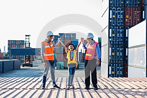 Business heir concept. Grandfather,  Father and daughter are standing in Container cargo harbor. They are happy together  because