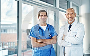 In the business of helping people get better. Portrait of two medical practitioners standing together in a hospital.