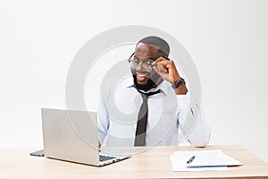 Business is his life. Cheerful young African man in formal wear and working on laptop