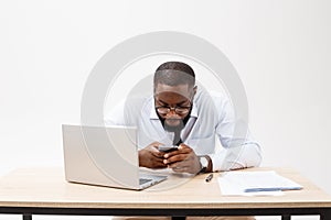 Business is his life. Cheerful young African man in formal wear and working on laptop