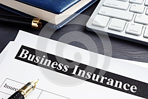 Business insurance policy and pen