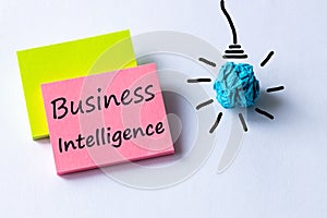 Business intelligence, written on a piece of paper, light bulb icon, concept for business plan, data mining, market analysis and