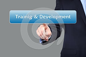 Business, internet concept - businessman pressing training and development button on virtual screens