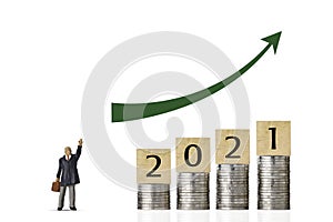 Business investment and growth year 2021 for advertising concept. Stacking coin growing with businessman standing with up arrow on