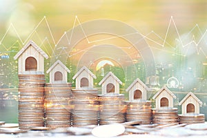 Business investment and real estate concept, Double exposure of growing model house and graph on stack of coins money on city