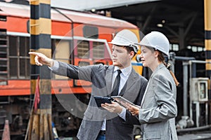 business investor engineer team working survey at site outdoor old locomotive depot diesel train yard plan for renovate