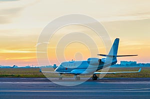 Business jet on the apron of aircraft. Dawn at