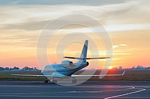 Business jet on the apron of aircraft. Dawn at
