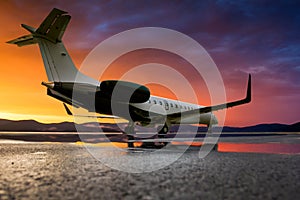 Business jet at the scenic sunset after the rain on the airport apron