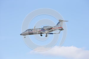 Business jet taking off isolated on a blue sky background.