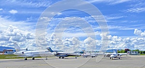 Business jets parked on the apron