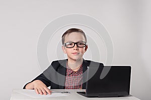 Business kid sitting in front of laptop