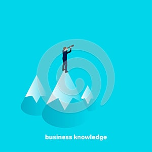 Business knowledge, isometric image, business man standing on a mountain and look out into the distance