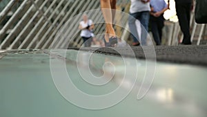 Business ladies and many people walking along bridge, hectic life in big city