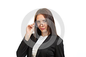 A business lady in a black jacket is holding her glasses. On white background