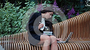 Business lady eating fresh salad after work day responding to a job offer email.