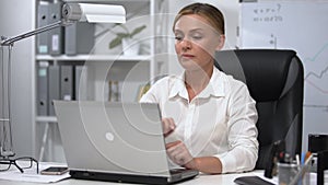 Business lady feeling pain in lower back trying to stand up after working day