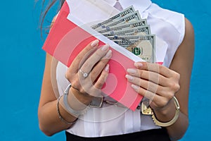 Business lady in handcuffs holding an envelope with dollars