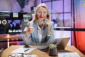 Business lady in headset having video chat on modern laptop
