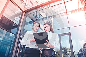 Business lady. Office staff. Two young girls with electronic tab photo