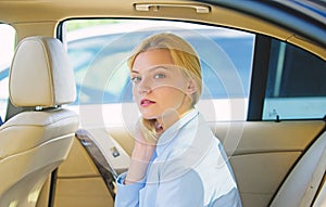 Business lady passenger luxury car salon. Personal assistant and driver. Business life concept. Business woman sit on