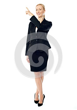 Business lady pointing upwards, copyspace concept