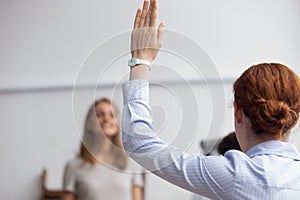 Business lady raise hand voting during business meeting