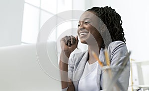 Business Lady Smiling Sitting At Laptop Against Window In Office