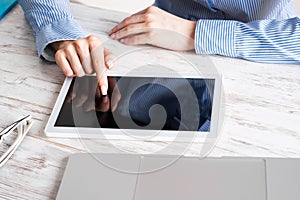 Business lady using tablet computer at desk