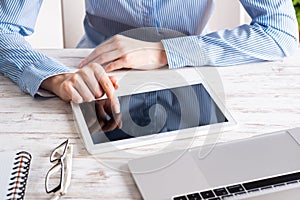 Business lady using tablet computer at desk