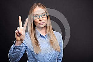 Business lady wearing blue glasses showing number two