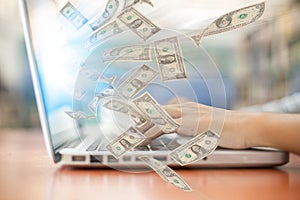 Business a laptop online business making money dollar bills