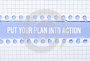 Business and law concept. Between two sheets of notebook on a blue background the inscription - PUT YOUR PLAN INTO ACTION