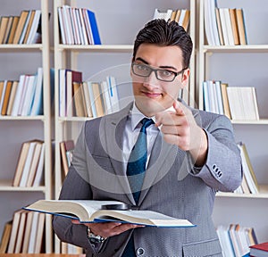 Business law student with magnifying glass reading a book