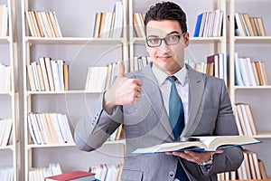 The business law student with magnifying glass reading a book