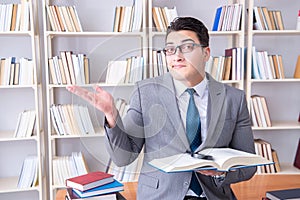 The business law student with magnifying glass reading a book