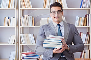 The business law student with pile of books working in library