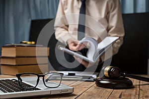 Business lawyer working hard at office desk workplace with book