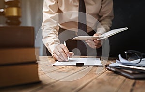 Business lawyer working hard at office desk workplace with book