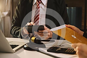 Business and lawyers discussing contract papers with brass scale on desk in office. Law, legal services, advice,  justice and law