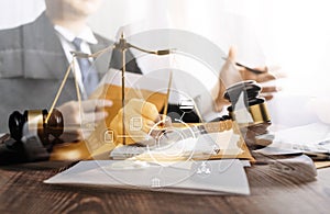 Business and lawyers discussing contract papers with brass scale on desk in office. Law, legal services, advice, justice and law