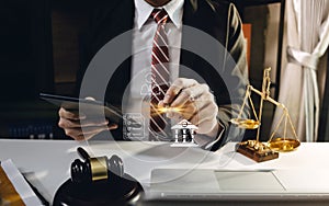 Business and lawyers discussing contract papers with brass scale on desk in office. Law, legal services, advice, justice and law