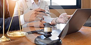 Business and lawyers discussing contract papers with brass scale on desk in office. Law, legal services, advice, justice and law