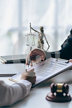Business lawyers working on law in a courtroom help clients read legal documents