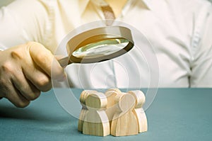 Business leader holding a magnifying glass over a team of workers. The concept of finding new employees. Teamliding. Team