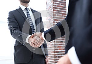 Business leader shaking hands with partner.