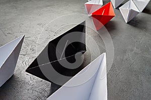 Business leadership Concept-Paper Boat key opinion Leader, influence concept. One black paper boat as a Leader, leading in the